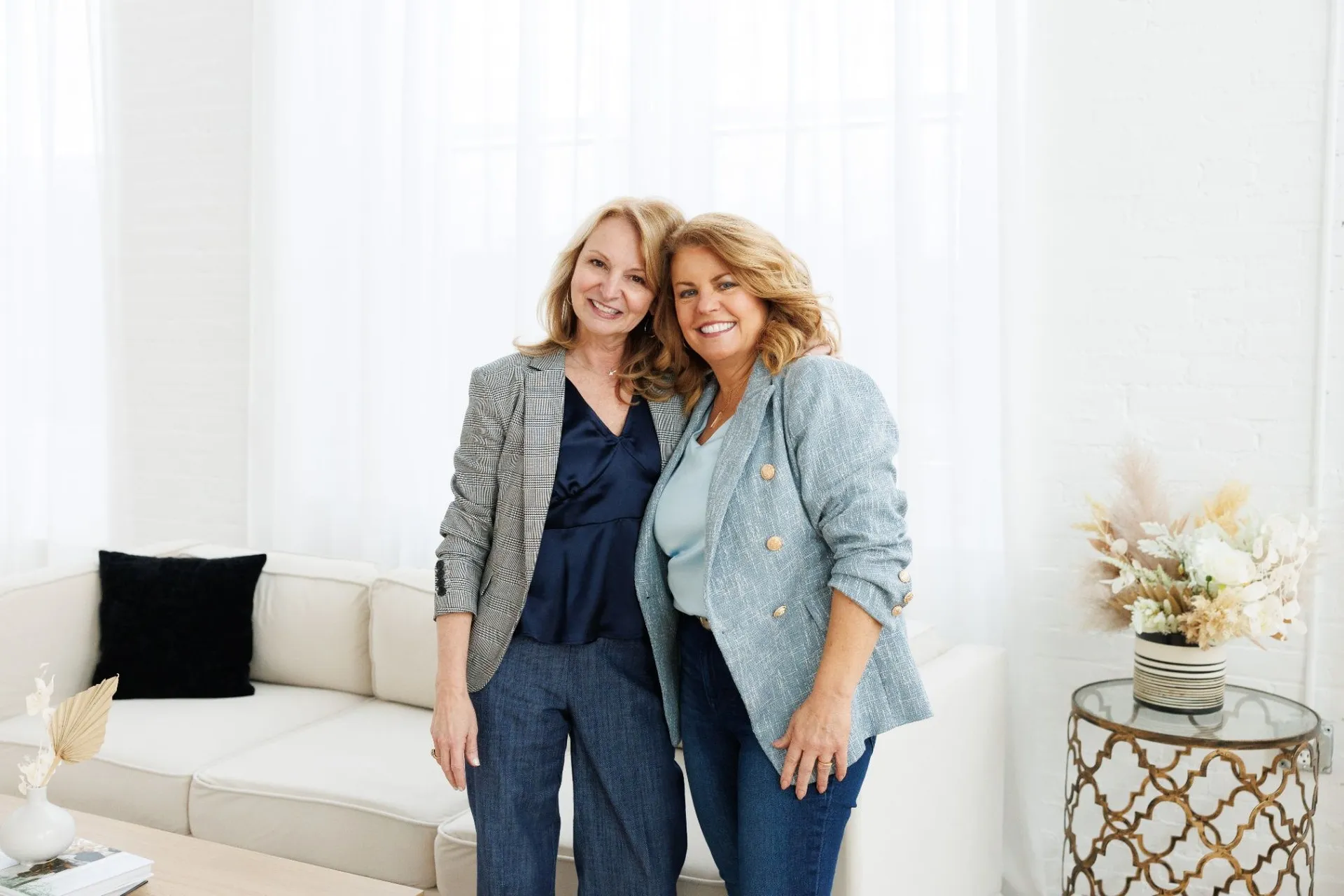 Donna and Lynn standing together in a bright studio portrait